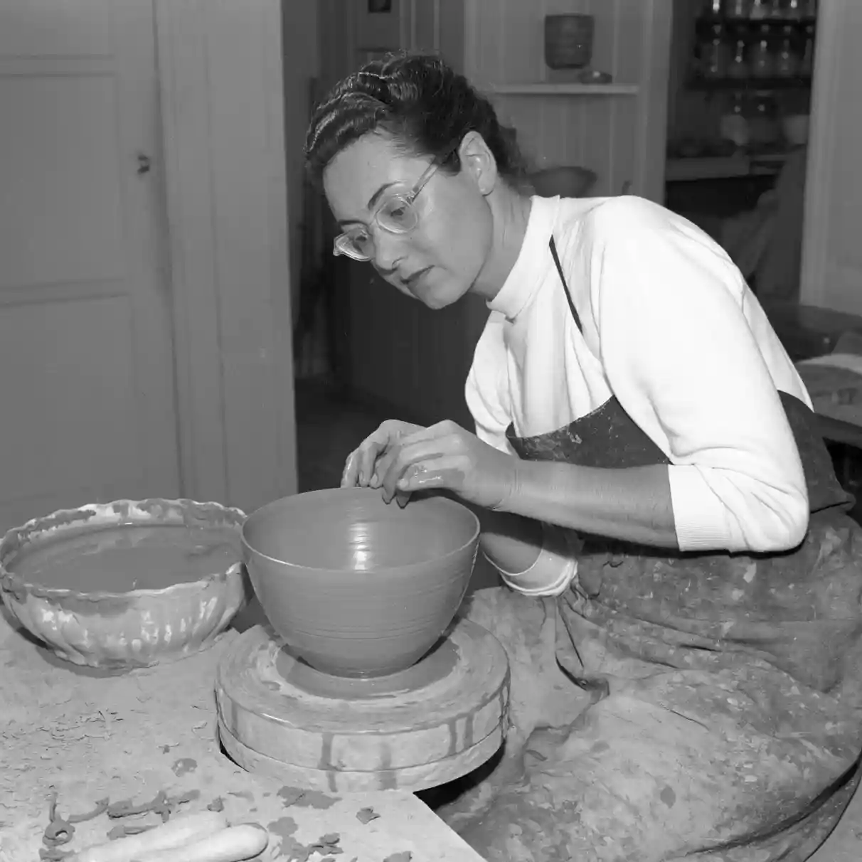 Gertrud at the wheel working on a bowl