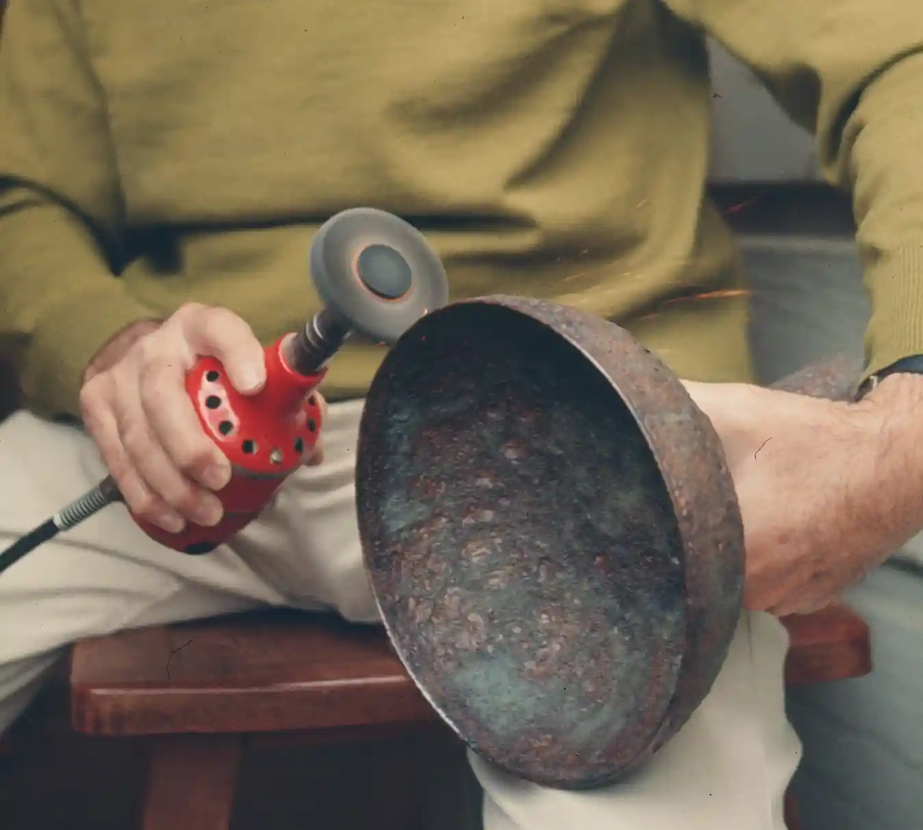 Otto using a polishing wheel on a bowl