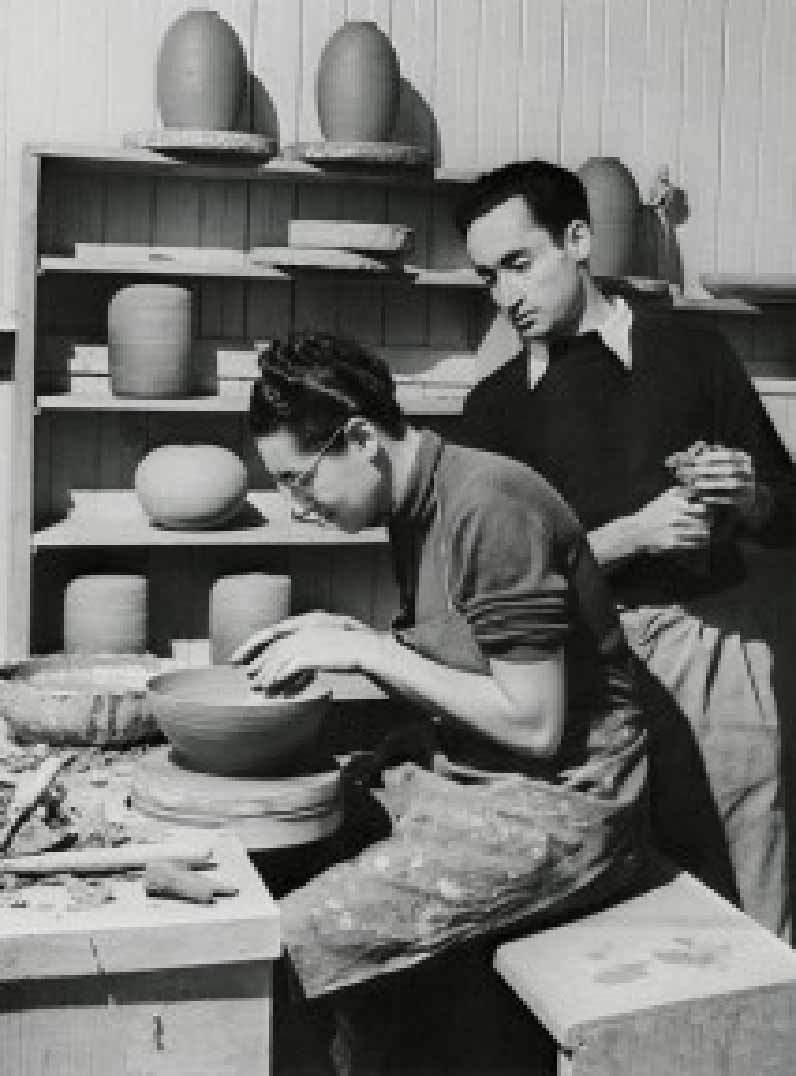 Gertrud shaping a bowl while Otto watches